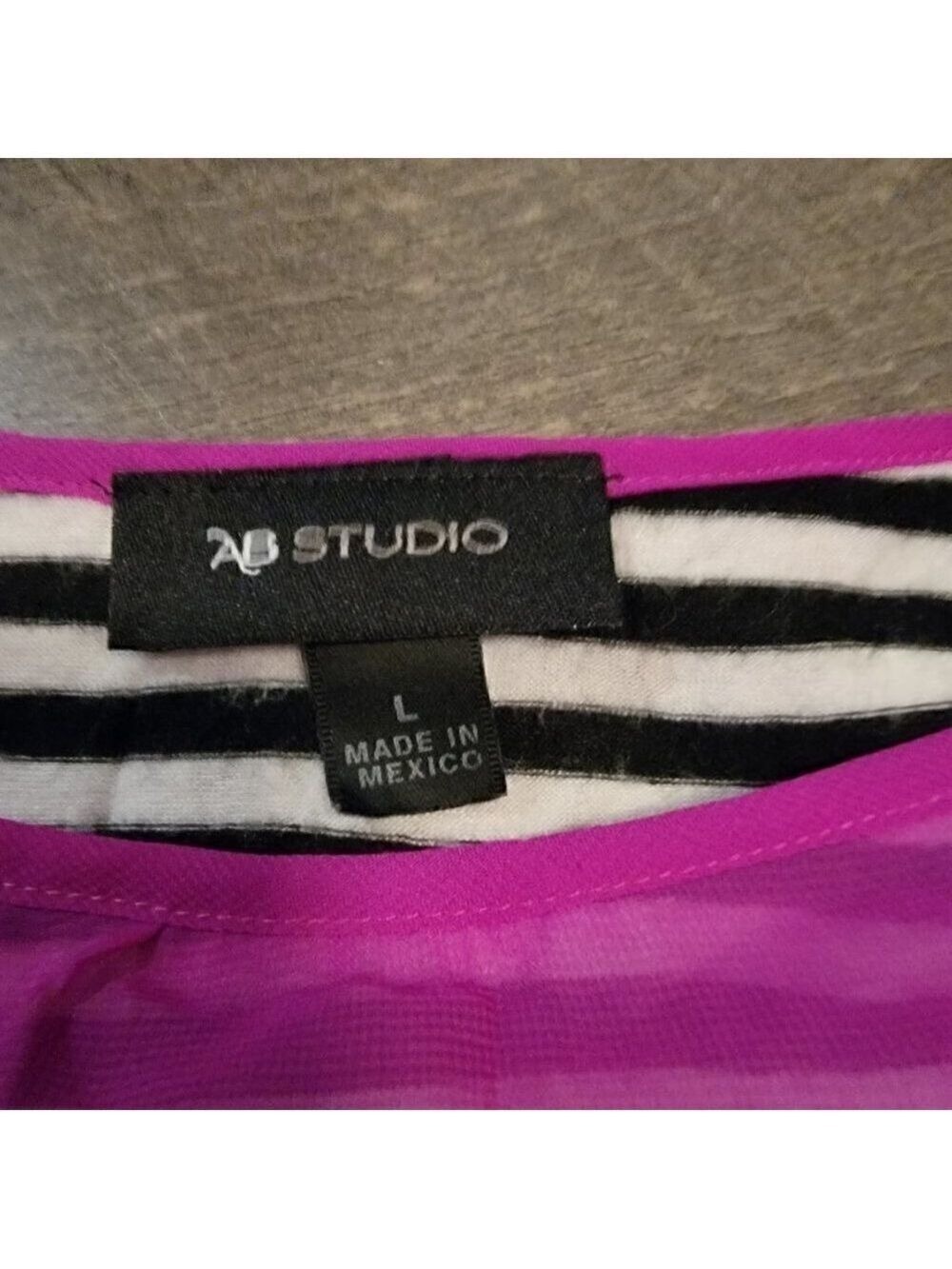 AB Studio bright pink shirt over a balck and white striped shirt